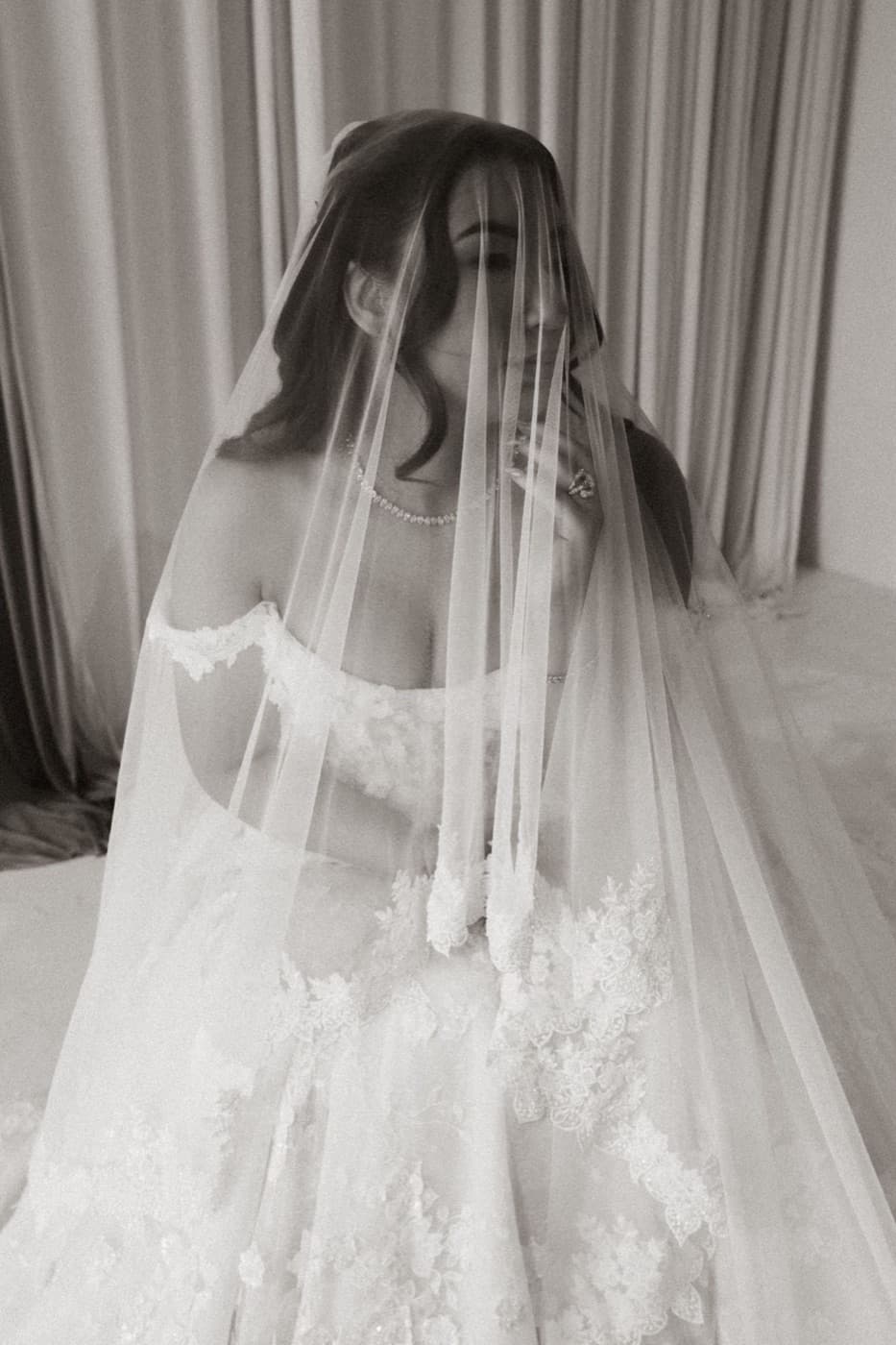 Ashley D. Tapia-Hans in a lace gown and veil